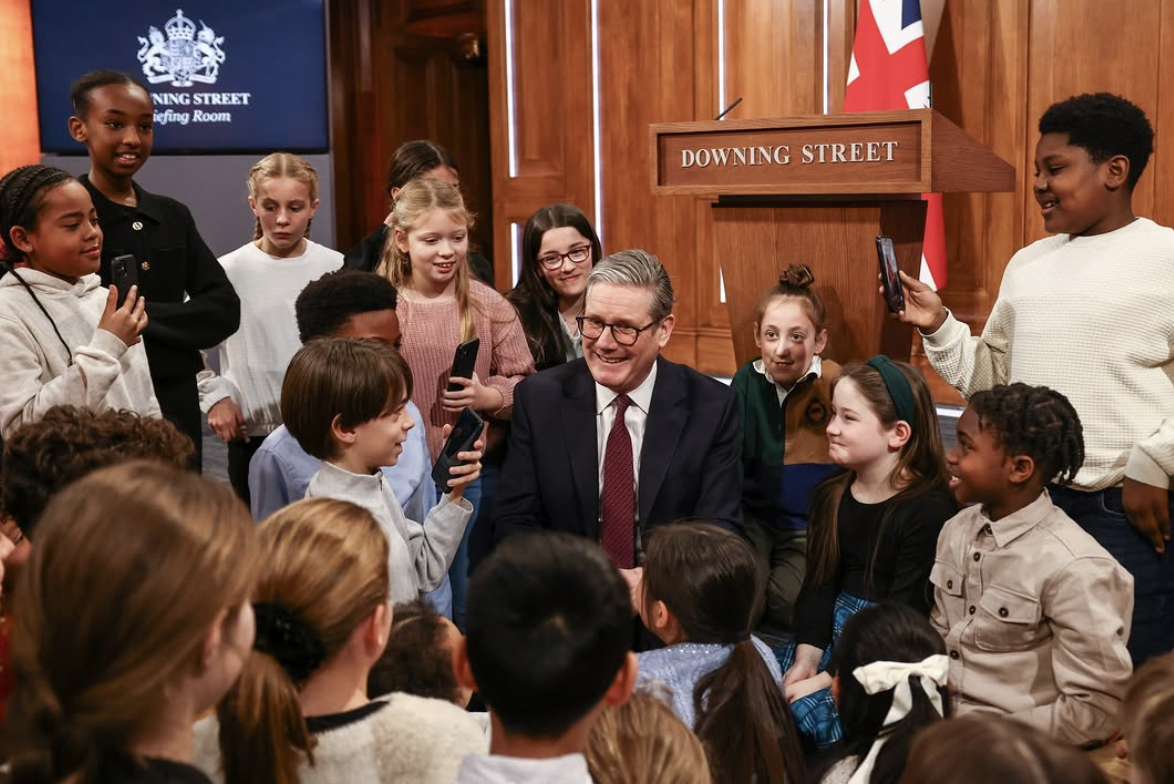 Sir Kier Starmer surrounded by kids armed with smartphones (Image: Labour/ Instagram)